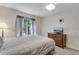 Comfortable bedroom features a window for natural light and a wood dresser at 3563 Watada Dr, Brighton, CO 80601