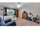 Bright bedroom with large window, ceiling fan, and workout equipment at 3563 Watada Dr, Brighton, CO 80601