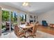 Cozy dining area with backyard views, a fireplace, and a ceiling fan at 3563 Watada Dr, Brighton, CO 80601