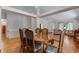 Open-concept dining area with hardwood floors, plenty of space, and natural light at 3563 Watada Dr, Brighton, CO 80601