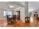 Bright dining area with hardwood floors, open to the living room and fireplace at 3563 Watada Dr, Brighton, CO 80601