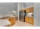 Well-equipped kitchen with stainless steel refrigerator, wood cabinets, and tiled floor at 3563 Watada Dr, Brighton, CO 80601