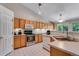 Well-lit kitchen with stainless steel oven, plentiful cabinets, and white countertops at 3563 Watada Dr, Brighton, CO 80601