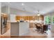 Bright eat-in kitchen with stainless steel appliances, light wood cabinetry, and vaulted ceiling at 3563 Watada Dr, Brighton, CO 80601