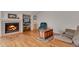 Comfortable living room with a fireplace, hardwood floors, and built-in shelving at 3563 Watada Dr, Brighton, CO 80601