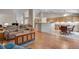 Bright and open living space with hardwood floors connecting the living, dining and kitchen areas at 3563 Watada Dr, Brighton, CO 80601