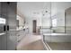 Bright, spacious bathroom featuring a large glass shower, soaking tub, and modern vanity with dual sinks at 5031 Moss Pl, Golden, CO 80403