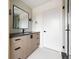 Modern bathroom features a vanity with sleek black hardware, a large mirror, and a glass-enclosed shower at 5031 Moss Pl, Golden, CO 80403
