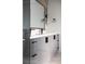 Modern bathroom featuring a sleek vanity with black hardware and a large mirror with black fixtures at 5031 Moss Pl, Golden, CO 80403
