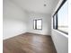 Minimalist bedroom with hardwood floors, large windows, and neutral decor, creating a serene space at 5031 Moss Pl, Golden, CO 80403