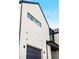 Modern two-story home with a sleek black garage door and minimalist architectural design at 5031 Moss Pl, Golden, CO 80403