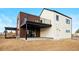 Contemporary home exterior featuring a brick accent wall, second-story balcony, and outdoor living space at 5031 Moss Pl, Golden, CO 80403