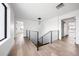 Bright hallway with hardwood floors, modern lighting, and access to multiple rooms at 5031 Moss Pl, Golden, CO 80403