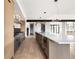 Modern kitchen with stainless steel appliances, a center island with seating, and ample counter space at 5031 Moss Pl, Golden, CO 80403