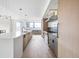Modern kitchen featuring stainless steel appliances, a center island with seating, and ample counter space at 5031 Moss Pl, Golden, CO 80403