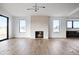 Inviting living room featuring a modern fireplace, hardwood floors, and large windows for ample natural light at 5031 Moss Pl, Golden, CO 80403