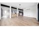 Open-concept living room with hardwood floors, modern shelving, and large windows offering abundant natural light at 5031 Moss Pl, Golden, CO 80403