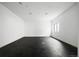 Empty bonus room offers versatile space with a modern dark gray floor and natural light at 5031 Moss Pl, Golden, CO 80403