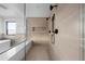 Luxurious walk-in shower with bench seating, dual shower heads, and elegant tile work at 5031 Moss Pl, Golden, CO 80403