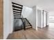 Modern staircase with open treads, metal railing, and hardwood flooring enhances this bright, contemporary home at 5031 Moss Pl, Golden, CO 80403