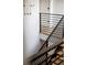 Staircase with modern black metal railings and light wood steps, creating an open and airy feel at 5031 Moss Pl, Golden, CO 80403