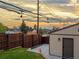 Fenced backyard with string lights, patio, and well-maintained lawn, creating an inviting outdoor space at 3401 N Steele St, Denver, CO 80205