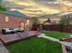 Inviting backyard with a wooden deck, comfortable seating, and a lush green lawn surrounded by a fence at 3401 N Steele St, Denver, CO 80205