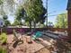 Cozy backyard with Adirondack chairs around a fire pit, a gravel area, and a privacy fence at 3401 N Steele St, Denver, CO 80205