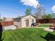Backyard showcasing a shed with a lawn area and a concrete pad, providing extra storage and functionality at 3401 N Steele St, Denver, CO 80205