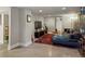 Finished basement living space with a large sofa, TV, and vibrant area rug on a concrete floor at 3401 N Steele St, Denver, CO 80205