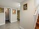 Finished basement hallway with gray walls and floors with access to a restroom and staircase at 3401 N Steele St, Denver, CO 80205