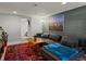 Finished basement with a large sofa, a wood coffee table, a vibrant area rug, and recessed lighting at 3401 N Steele St, Denver, CO 80205