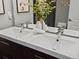 Bright bathroom featuring a double sink vanity, modern faucets, and a decorative plant arrangement at 3401 N Steele St, Denver, CO 80205