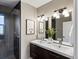 Modern bathroom with double vanity, sleek fixtures, framed alpaca prints and a glass enclosed walk-in shower at 3401 N Steele St, Denver, CO 80205