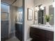 Contemporary bathroom showcasing glass enclosed shower and modern double vanity, and alpaca art at 3401 N Steele St, Denver, CO 80205