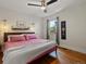 Bright bedroom featuring hardwood floors, a cozy bed, and stylish decor at 3401 N Steele St, Denver, CO 80205