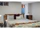 Well-lit bedroom with window and accent furniture at 3401 N Steele St, Denver, CO 80205