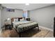 A bedroom with natural light filtering through a window and a cozy, patterned blanket on the bed at 3401 N Steele St, Denver, CO 80205