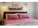 Comfortable bedroom with plush pink bedding and decorative wall art at 3401 N Steele St, Denver, CO 80205