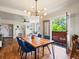 Bright dining room with stylish lighting fixture and direct access to an outdoor balcony at 3401 N Steele St, Denver, CO 80205