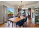Bright dining room with hardwood floors, table, chairs, and access to the balcony at 3401 N Steele St, Denver, CO 80205