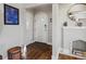 Welcoming entryway featuring hardwood floors, arched doorway, and decorative fireplace mantel at 3401 N Steele St, Denver, CO 80205