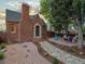 Charming brick home with a stone walkway leading to the front door and a cozy outdoor seating area at 3401 N Steele St, Denver, CO 80205