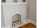 White fireplace with logs on a hardwood floor at 3401 N Steele St, Denver, CO 80205