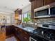 Kitchen with stainless steel appliances, dark wood cabinets, and tile backsplash at 3401 N Steele St, Denver, CO 80205