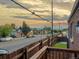 Charming neighborhood street view from a wooden deck showing houses and a picturesque skyline at dusk at 3401 N Steele St, Denver, CO 80205