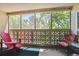 Relaxing screened-in patio with comfortable seating and views of lush greenery at 3164 S Wheeling Way # 302, Aurora, CO 80014