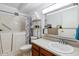Well-lit bathroom featuring a walk-in tub, modern sink, and storage shelving for added convenience at 3164 S Wheeling Way # 302, Aurora, CO 80014