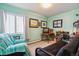 Comfortable bedroom with a large window, cozy futon, and ample space for relaxation and work at 3164 S Wheeling Way # 302, Aurora, CO 80014