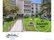 Inviting condo building exterior with manicured lawn and accessible ramp entrance at 3164 S Wheeling Way # 302, Aurora, CO 80014